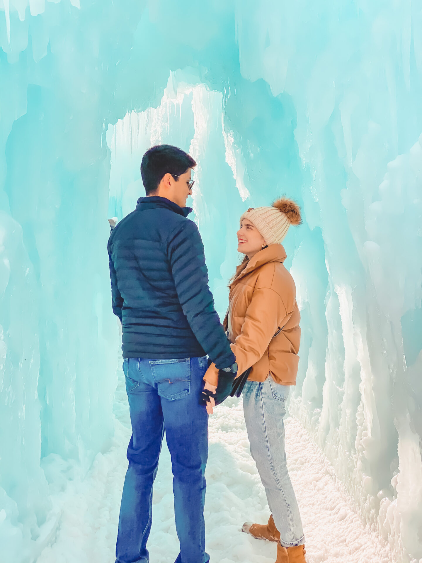 Couple holding hands at the Midway Ice Castles, Tips for Visiting the Ice Castles in Midway, UT - Palm Trees and Pellegrino Travel Tips