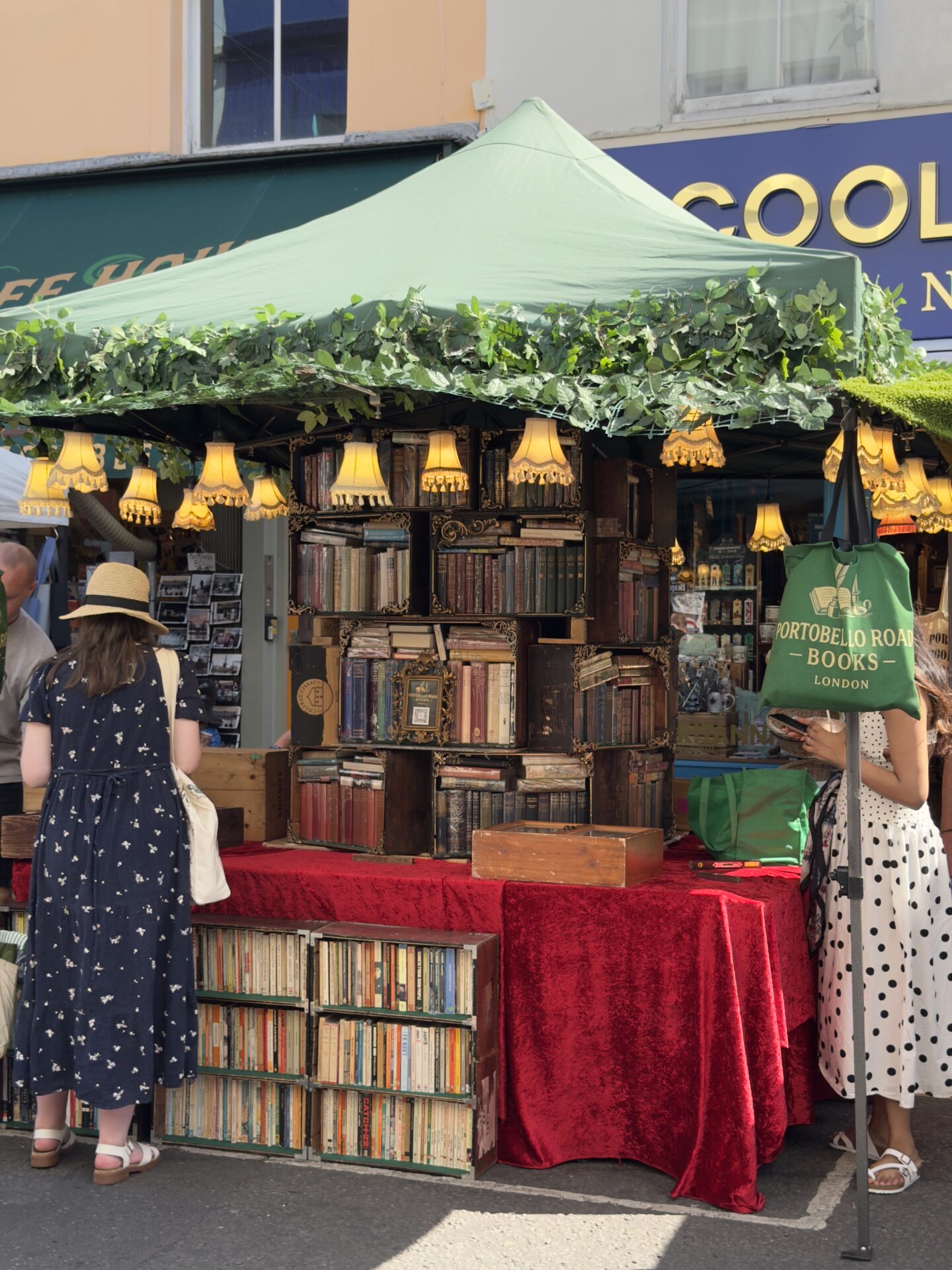 Portobello Rare Books at Stall 40 on Portobello Road market — an outdoor market stall displaying vintage and antiquarian books, including rare children's illustrated editions, first editions, and classic literature, arranged across tables and shelving.