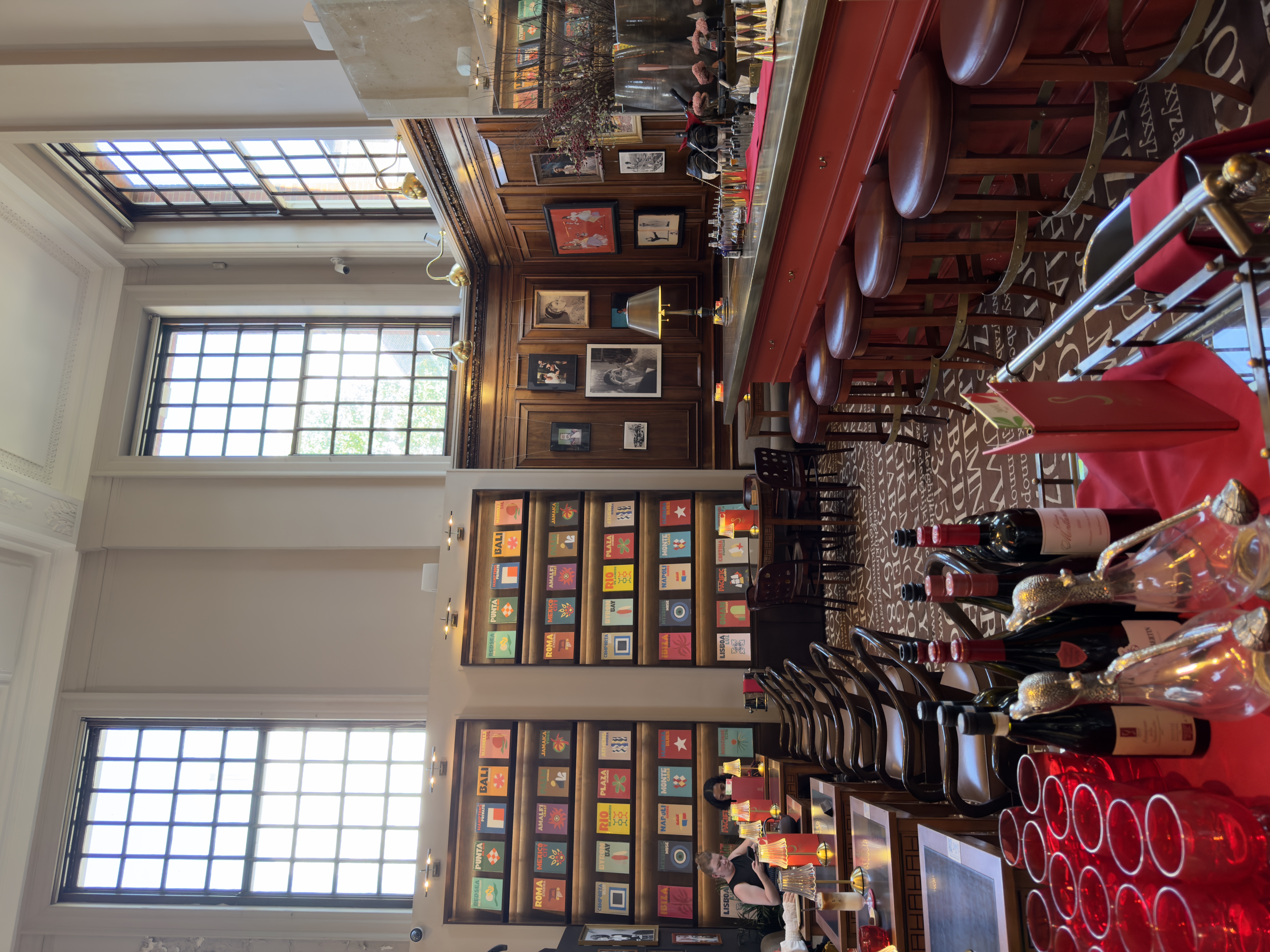 Inside Maison Assouline, Piccadilly — a lavish, salon-style bookshop with dark wood shelving, marble accents, and curated displays of luxury art and travel books.